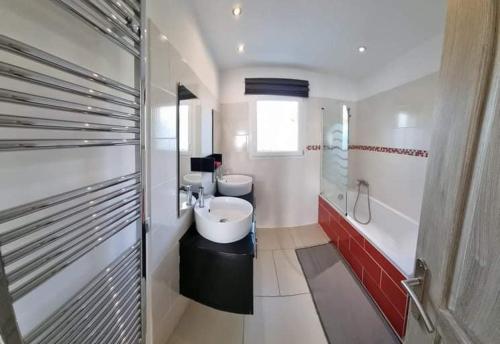 a white bathroom with two sinks and a shower at Gites de la Casasole in Vogüé