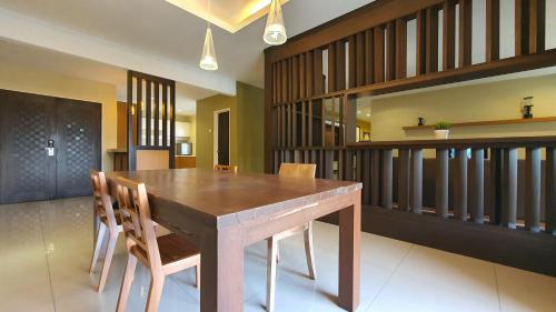 a dining room with a wooden table and chairs at Gold Coast Morib Studio l Apartment I Penthouse in Banting
