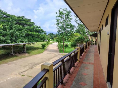 a balcony of a building with a fence and a road at Nakakiri Resort & Spa in Hin Dat