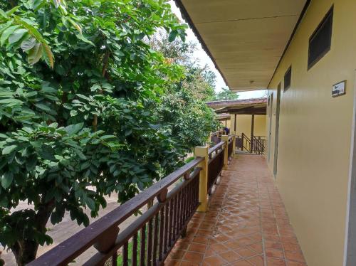 a hallway of a building with a fence and trees at Nakakiri Resort & Spa in Hin Dat