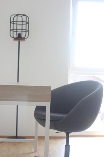 a desk with a chair next to a table at BNB Klinga in Klinga