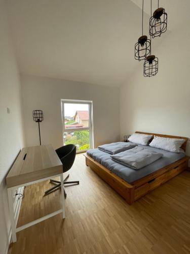 a bedroom with a bed and a desk and a window at BNB Klinga in Klinga