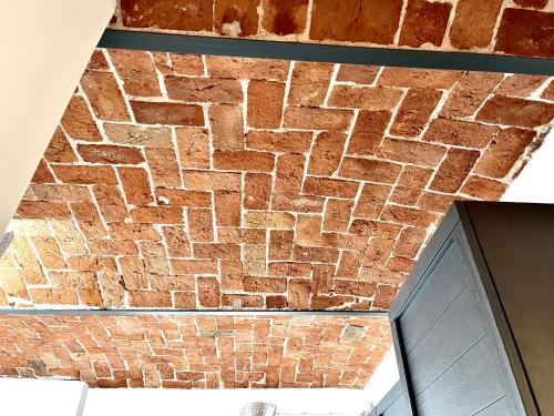 an overhead view of a brick wall next to a door at Cá d la trifola free parking in Alba