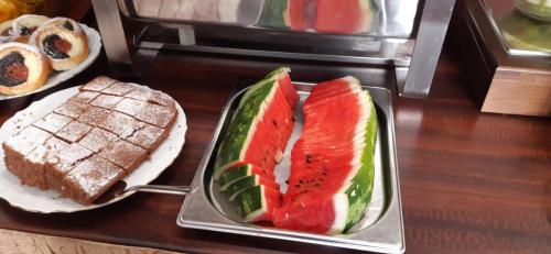 a tray of food with watermelon and bread on a table at Spa Hotel Purkyně in Karlovy Vary