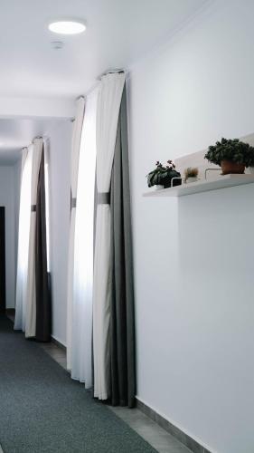 a row of white curtains on a wall at Апарт отель Welcome in Taldykorgan