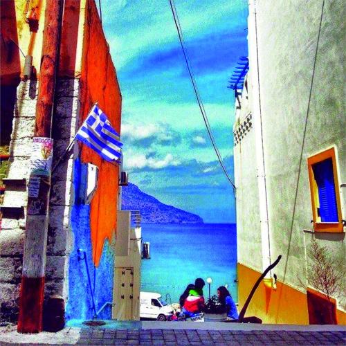 a view of the ocean from the side of a building at Arhontiko Hotel in Foinikion