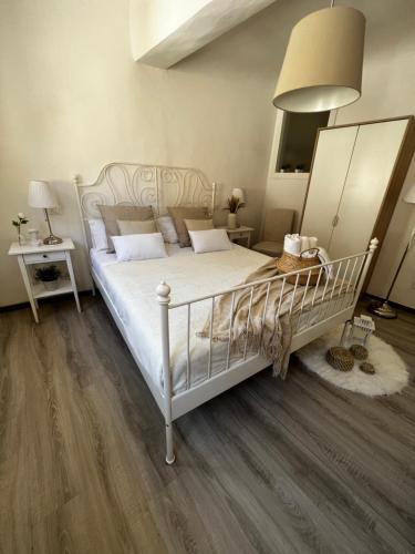 a bedroom with a white bed and a mirror at La Piccola Maison in Florence