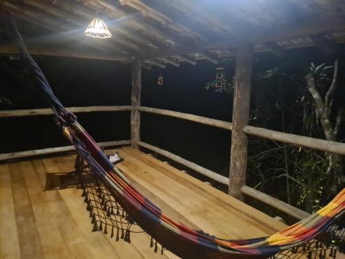 a hammock in a room with a ceiling at Casa na praia do Felix na cidade de Ubatuba in Ubatuba