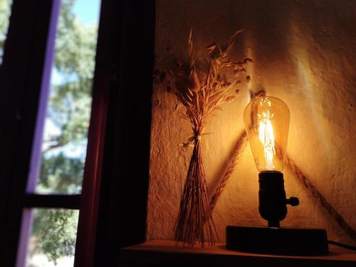 a lamp sitting on a table next to a wall at holiday home su Niberalzu in Monti