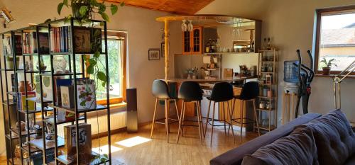 a living room with a counter and a bar with stools at Spacious house with indoor pool & sauna. in Ādaži