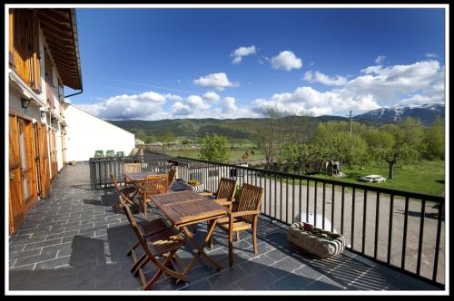 a patio with a table and chairs and a fence at Mas Meya in Puigcerdà