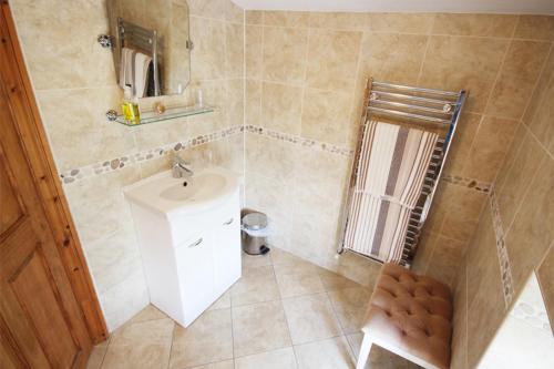 a bathroom with a sink and a mirror at Fernydale Farm Bed & Breakfast in Earl Sterndale