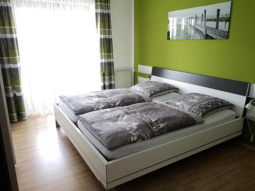 2 Betten in einem Zimmer mit grünen Wänden in der Unterkunft Ferienwohnung-Kappl in Tännesberg
