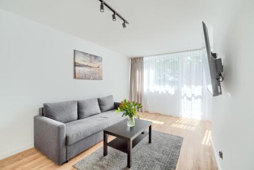 a living room with a couch and a table at APARTAMENT SŁONECZNY in Chełmno