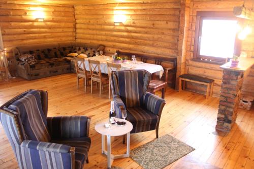 a dining room with a table and chairs and a window at Zaķu muiža in Anspoki