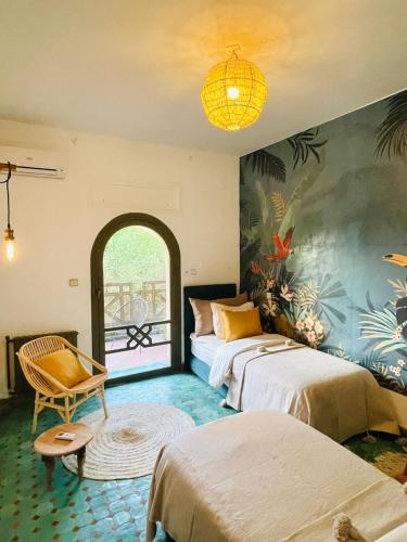 a hotel room with two beds and a window at La Vie En Rose - Horses & Dogs House in Marrakesh