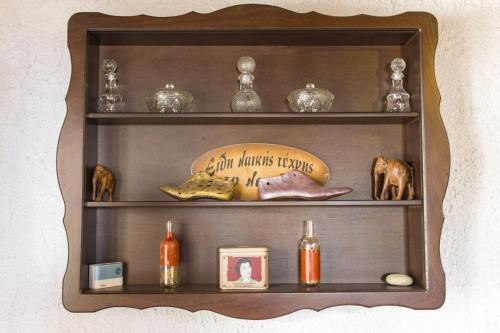 a wooden shelf with various items on it at Hotel Mitikas in Livádion