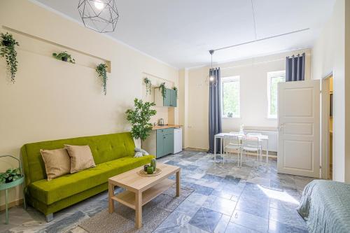a living room with a green couch and a table at The house Kaunas in Kaunas