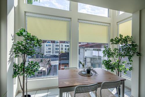 a dining room with a table and a large window at The house Kaunas in Kaunas