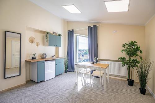 a kitchen with a table and a dining room at The house Kaunas in Kaunas
