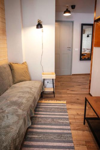 a living room with a couch and a table at CASA HINTZ Transilvania in Făgăraş