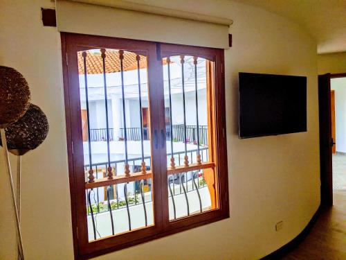 a room with a window with a view of a balcony at OFF HOSTEL in Villa de Leyva