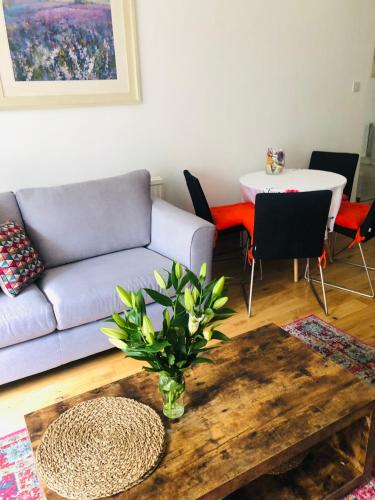a living room with a couch and a table at 2 Bedroom Apartment close to Camden Town in London