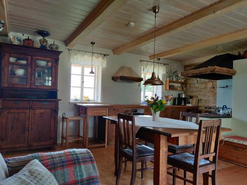 a kitchen with a table and chairs in a room at Hansi Puhkemaja in Kuivastu