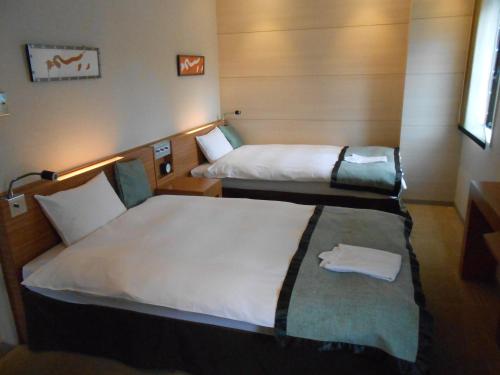 Postel nebo postele na pokoji v ubytování My Hotel Ryugu
