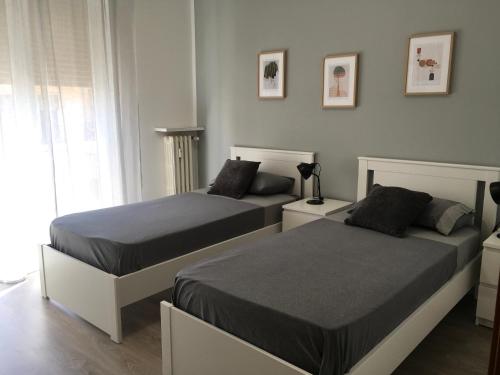 a bedroom with two beds and a window at Casa di Babi in Verona