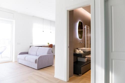 een woonkamer met een bank en een stoel bij 7th floor apartment in Foggia