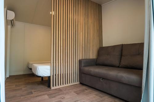 a living room with a couch and a bed at Camping Cambrils Caban in Cambrils