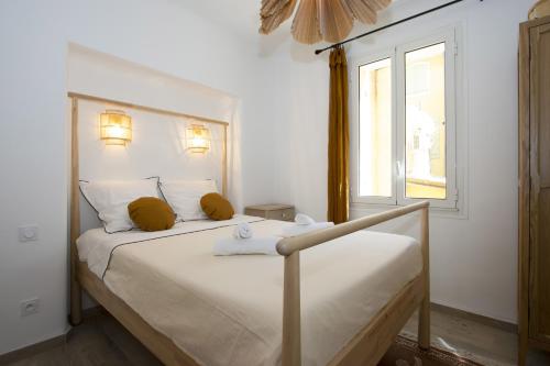 a bedroom with a large white bed with a window at La Ciotat AUTHENTIQUE - T3 à 2 pas du port et des plages - Parking souterrain offert in La Ciotat