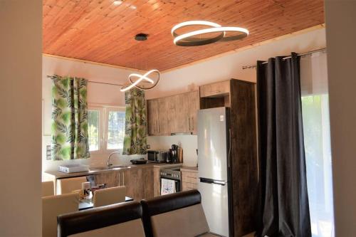 a kitchen with a white refrigerator and wooden cabinets at Hephaestus Appartments Litochoro -A1 in Litochoro