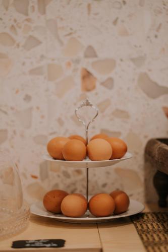 a three tiered plate with brown eggs on it at CasadoRioHotel in Constância
