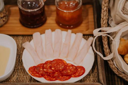 a plate of food with a bowl of sauce at CasadoRioHotel in Constância