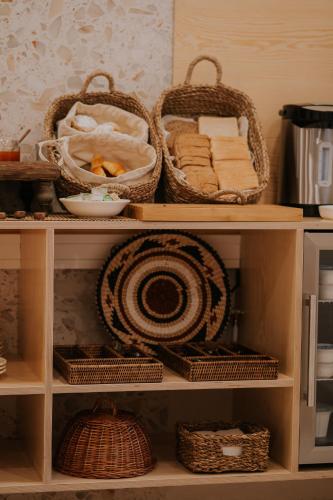 a shelf with baskets and other items on it at CasadoRioHotel in Constância