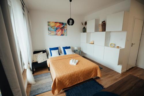 a bedroom with a bed with a orange blanket at Blue_Loft in Sandomierz