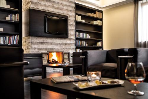 a living room with a couch and a fireplace at Hotel Il Cantico St. Peter in Rome