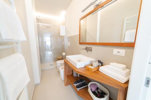 a bathroom with a sink and a mirror and a toilet at Casa Agnese in Alba