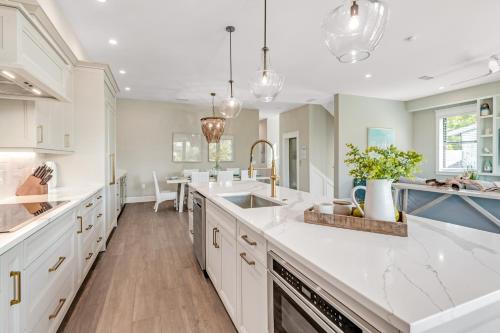 a large kitchen with white counters and a sink at Shore Thing in Sarasota