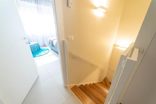 a bathroom with a stairway leading to a window at Casa Agnese in Alba