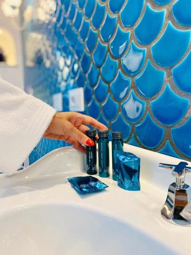 a person washing their hands on a bathroom sink at Villa Diamond Luxury Suite in Positano