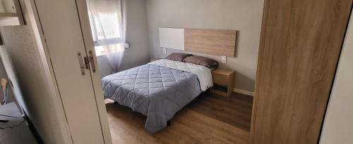 a small bedroom with a bed and a window at Tenerias 2 in Castellón de la Plana