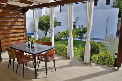 a dining room table and chairs on a patio at Villa Klara in Vodice
