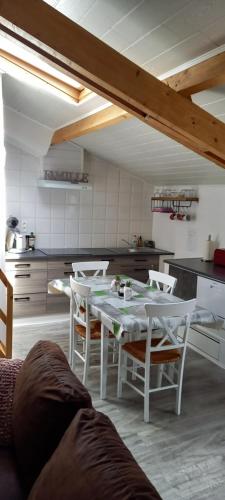 a kitchen with a table and chairs in a room at chez Christelle in Rochefort