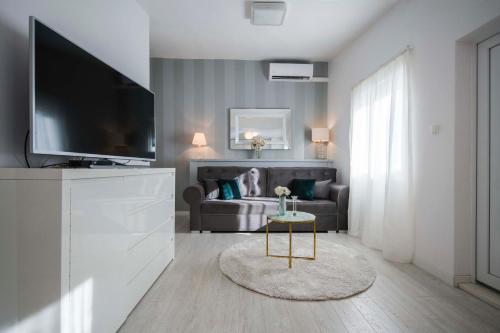 a living room with a couch and a television at LUX GARDEN Luxury Apartment Split in Split