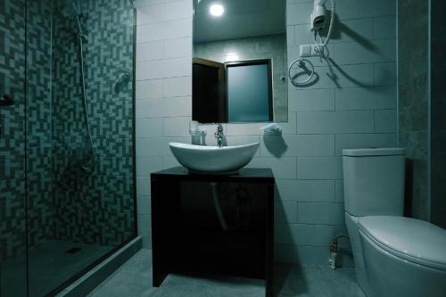 a bathroom with a sink and a shower and a toilet at Hotel Rero in Kutaisi