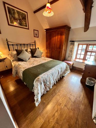 a bedroom with a bed and a chandelier at Cwmgwn Farm in Llandovery