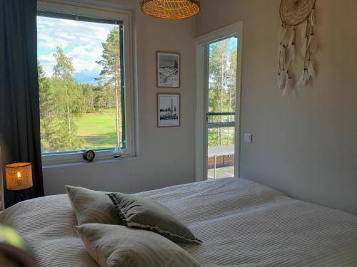 a bedroom with a bed and a large window at Asunto Kalajoen Golfpuistossa in Kalajoki